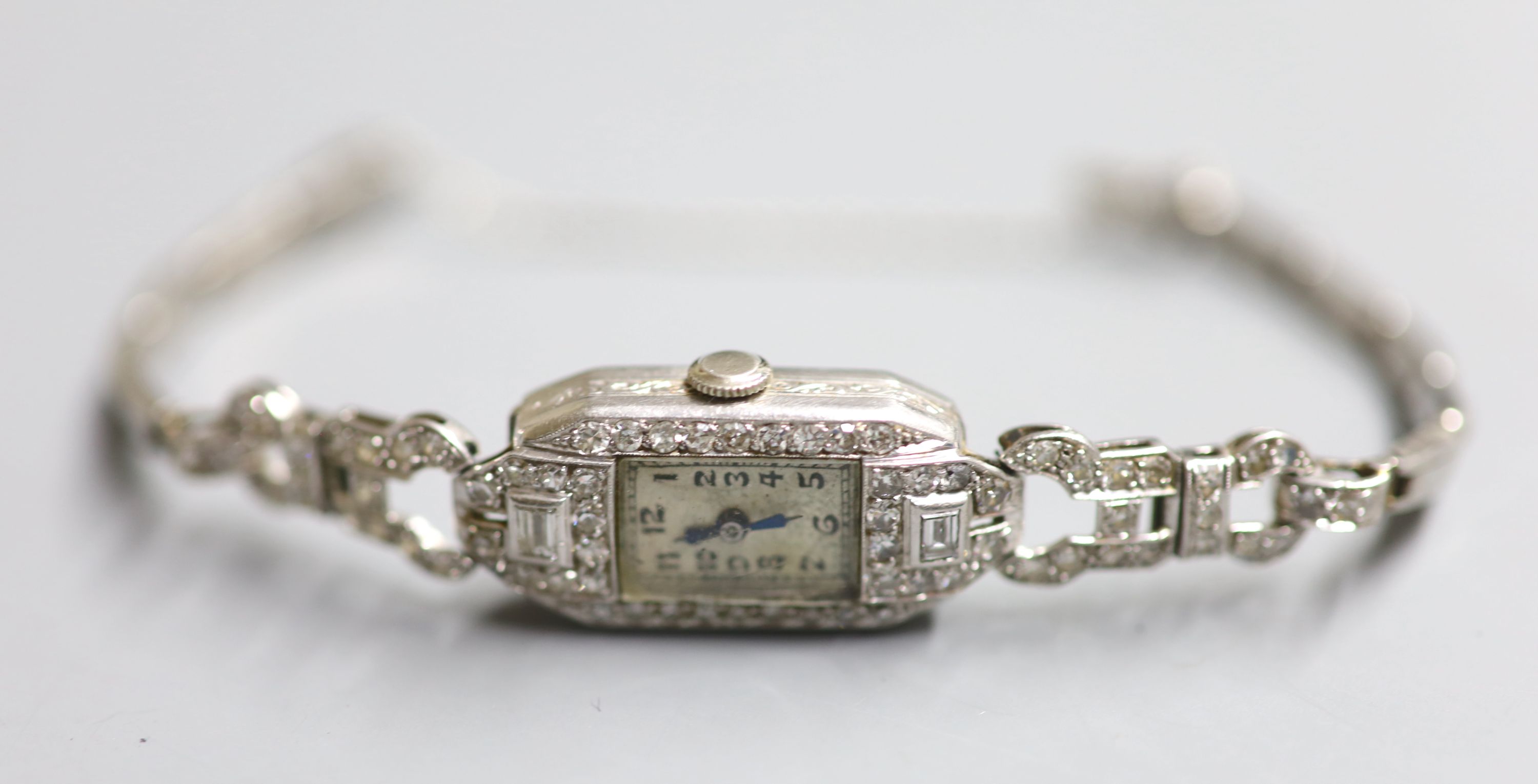 A ladys 1940s white metal (stamped platinum) and diamond set cocktail watch,